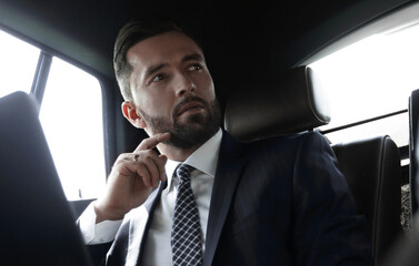 businessman working with laptop and looking out the window of a