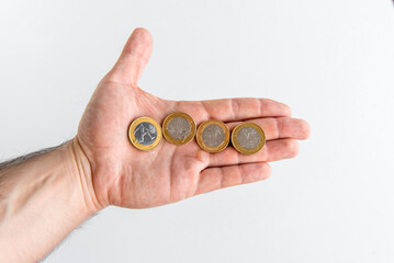 Fototapeta premium Hand holding Brazilian commemorative coins, Brazilian real coins.