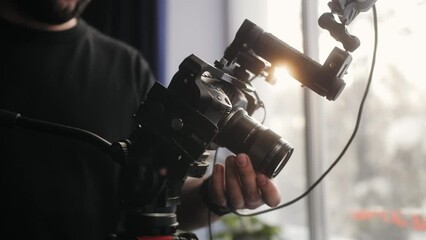 Video production backstage. Professional camera man creating video content in studio, commercial filming. - Powered by Adobe