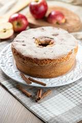 Sponge cake or chiffon cake with apples so soft and delicious sliced ​​with ingredients: cinnamon, eggs, flour, apples on wooden table. Home bakery concept for background and wallpaper