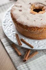 Sponge cake or chiffon cake with apples so soft and delicious sliced ​​with ingredients: cinnamon, eggs, flour, apples on wooden table. Home bakery concept for background and wallpaper