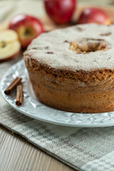 Sponge cake or chiffon cake with apples so soft and delicious sliced ​​with ingredients: cinnamon, eggs, flour, apples on wooden table. Home bakery concept for background and wallpaper