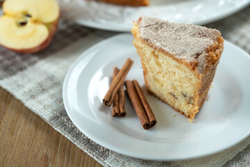 piece of Sponge cake or chiffon cake with apples so soft and delicious sliced ​​with ingredients: cinnamon, eggs, flour, apples on wooden table. Home bakery concept for background and wallpaper