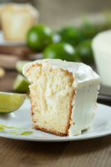 Close up piece of Moist lemon fruit cake on plate with lemon slices on wooden table. Delicious breakfast, traditional tea time. Lemon cake recipe.