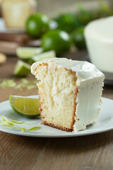 Close up piece of Moist lemon fruit cake on plate with lemon slices on wooden table. Delicious breakfast, traditional tea time. Lemon cake recipe.