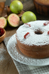 Brazilian corn cake made with a type of corn flour (Fuba) filled with guava paste. On a wooden party table. Typical sweets of the June festival. Cornmeal cake