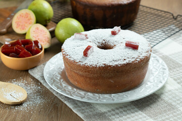 Brazilian corn cake made with a type of corn flour (Fuba) filled with guava paste. On a wooden party table. Typical sweets of the June festival. Cornmeal cake