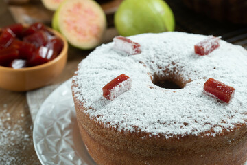 Brazilian corn cake made with a type of corn flour (Fuba) filled with guava paste. On a wooden party table. Typical sweets of the June festival. Cornmeal cake