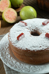 Brazilian corn cake made with a type of corn flour (Fuba) filled with guava paste. On a wooden party table. Typical sweets of the June festival. Cornmeal cake