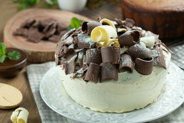 White chocolate and dark chocolate cake two loves on wooden table. Birthday and wedding cake