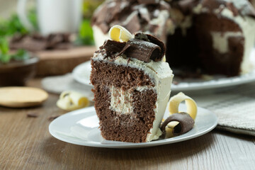 Close up piece of White chocolate and dark chocolate cake two loves on wooden table. Birthday and wedding cake