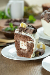 Close up piece of White chocolate and dark chocolate cake two loves on wooden table. Birthday and wedding cake