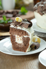 Close up piece of White chocolate and dark chocolate cake two loves on wooden table. Birthday and wedding cake