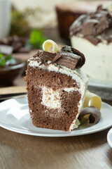 Close up piece of White chocolate and dark chocolate cake two loves on wooden table. Birthday and wedding cake