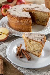 piece of sponge cake or chiffon cake with apples so soft and delicious sliced ​​with ingredients: cinnamon, eggs, flour, apples on wooden table. Home bakery concept for background and wallpaper