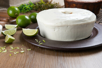 Moist lemon fruit cake on plate with lemon slices on wooden table. Delicious breakfast, traditional tea time. Lemon cake recipe.