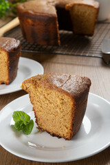 Close up piece of Brazilian corn cake made with a type of corn flour (Fuba). On a wooden party table. Typical sweets of the June festival. Cornmeal cake