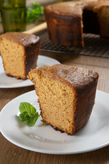 Close up piece of Brazilian corn cake made with a type of corn flour (Fuba). On a wooden party table. Typical sweets of the June festival. Cornmeal cake