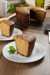 Close up piece of Brazilian corn cake made with a type of corn flour (Fuba). On a wooden party table. Typical sweets of the June festival. Cornmeal cake