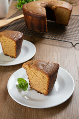 Close up piece of Brazilian corn cake made with a type of corn flour (Fuba). On a wooden party table. Typical sweets of the June festival. Cornmeal cake