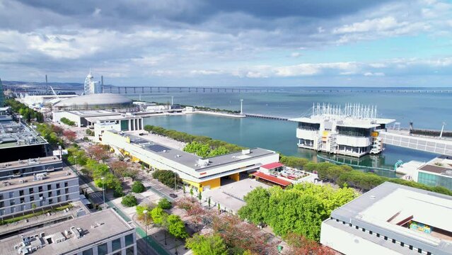 Lisbon, Portugal, April 24, 2022: DRONE AERIAL FOOTAGE: The Parque das Nacoes (Park of Nations), is a neighborhood in Lisbon constructed for the 1998 Lisbon World Exposition.