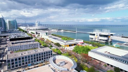 Lisbon, Portugal, April 24, 2022: DRONE AERIAL FOOTAGE: The Parque das Nacoes (Park of Nations), is a neighborhood in Lisbon constructed for the 1998 Lisbon World Exposition.