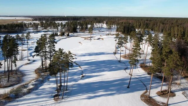 Golf course frozen with little forest on the par 5
