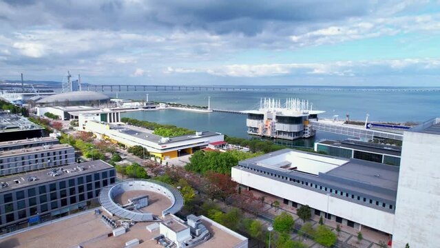 Lisbon, Portugal, April 24, 2022: DRONE AERIAL FOOTAGE: The Parque das Nacoes (Park of Nations), is a neighborhood in Lisbon constructed for the 1998 Lisbon World Exposition.