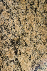 Tile texture with yellowish and black coloring. Top view