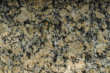 Tile texture with yellowish and black coloring. Top view