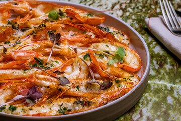 some langoustines on a plate on green marble table macro close up