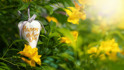 A wooden heart in garden with texts Happy mother's day,Happy mother's day concept background.