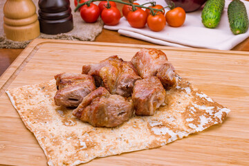 Kebab of pork on the board macro close up