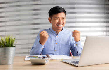  happy businessman in desk look at laptop read receive great news online celebrate success win result concept