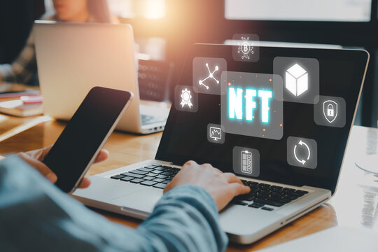 NFT token digital crypto art blockchain technology concept, Person hand using smartphone and laptop computer with NFT icon on virtual screen.
