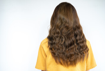 Rear view of young woman with her curly hair isolated on white background.