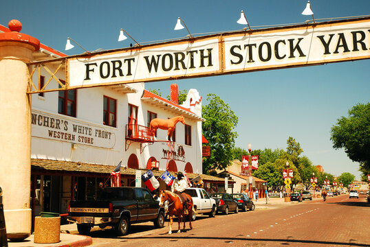 A sheriff patrols the streets of the Fort Worth Stockyards while riding on a horse 