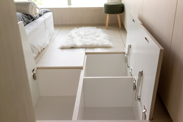 Hidden closet in floor in the bedroom. Creative storage ideas for small spaces. Selective focus image.