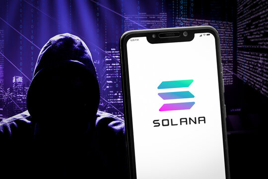 Cali, Colombia - April 26 2022: Solana logo on the smartphone screen and the concept of hacker at the blurred background.