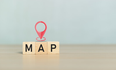 Concept of navigation direction travel. Pink pin map location icon over on wooden cube block with...