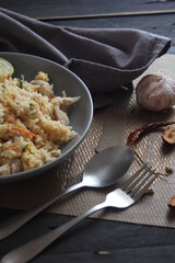 Pork fried rice is a common street food in Thailand. Served on a black wooden table.