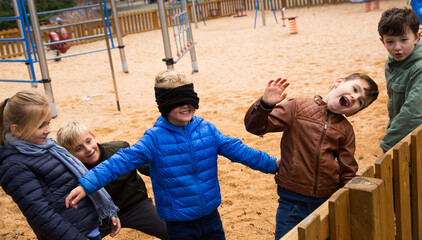 Obraz premium Children play in the blind man's buff. High quality photo