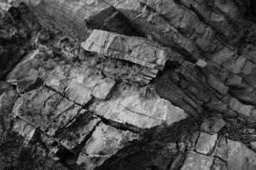 Black white rock texture. Collapsed. Crushed stone background for design. Grunge. Distressed.