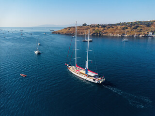 Obraz premium Aerial view of a white yacht crossing Bodrum Harbor, Turkey