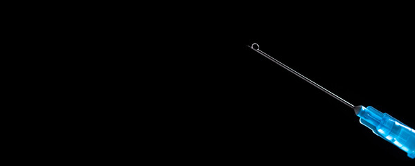 Medical syringe with a needle and vaccine against corona virus.