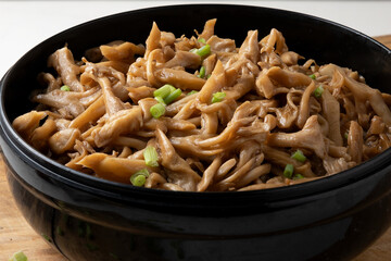Shimeji mushrooms served with chives on a bowl.