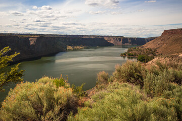 Beautiful landscape in The Cove Palisades State Park in Oregon. Desert cliffs frame Lake Billy...