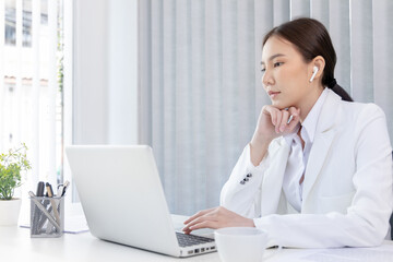 Businesswoman using laptop to work, Asian woman working in the office, World of technology and internet communication, Using computers to conduct financial transactions because the convenience.