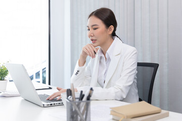 Businesswoman using laptop to work, Asian woman working in the office, World of technology and internet communication, Using computers to conduct financial transactions because the convenience.