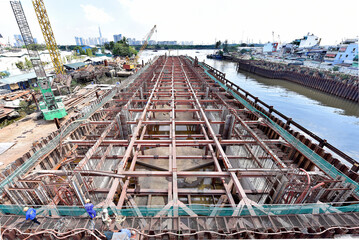 Large construction in the river for urban flood prevention. Industry execution of the steel foundation and concreting.
